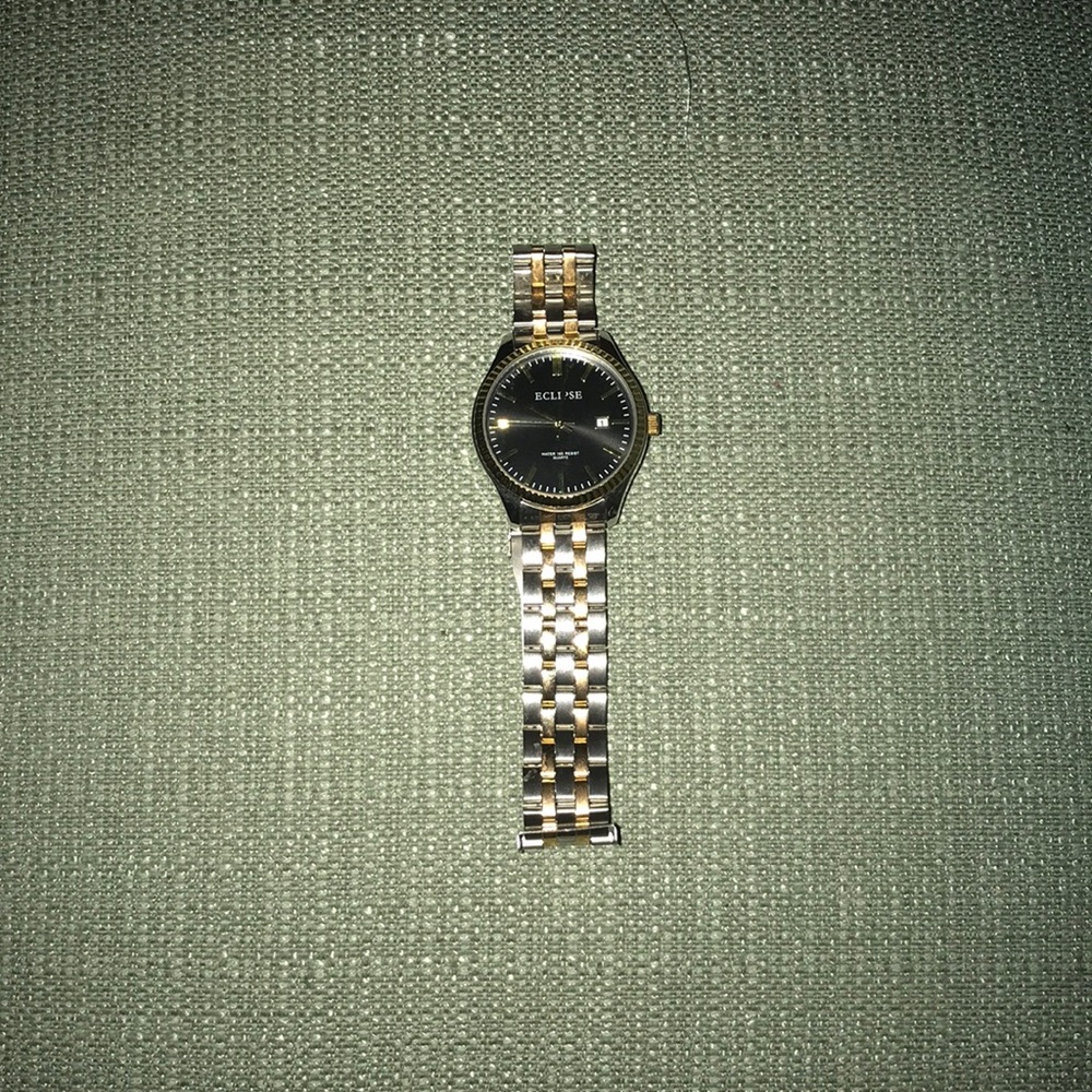 A shiny silver and gold eclipse watch